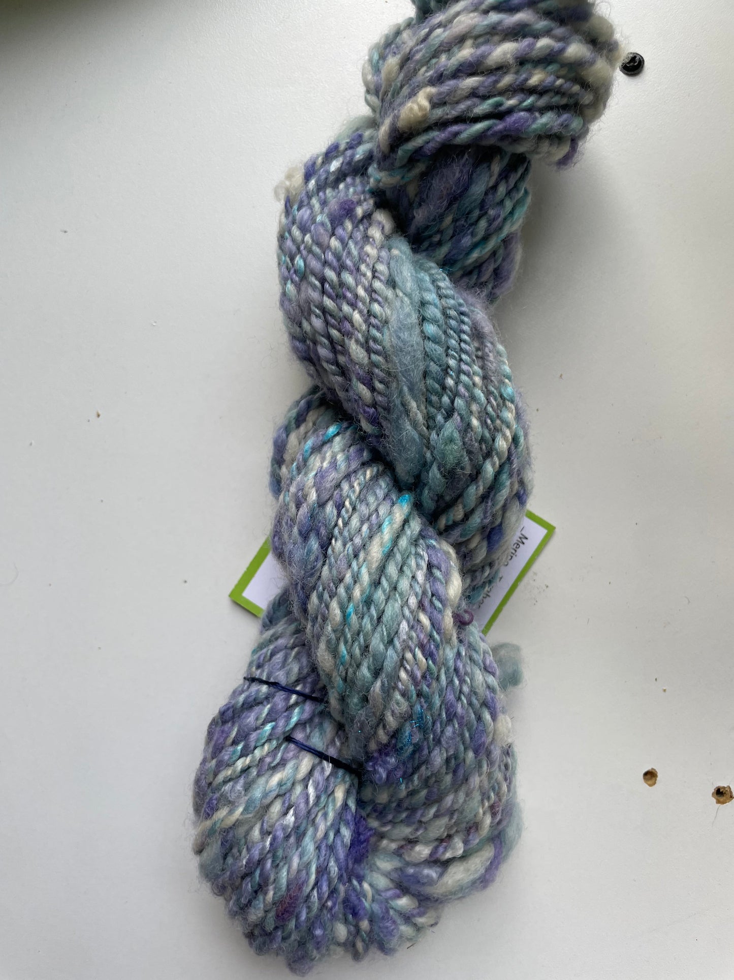 Blue and gray skein of yarn on a white background