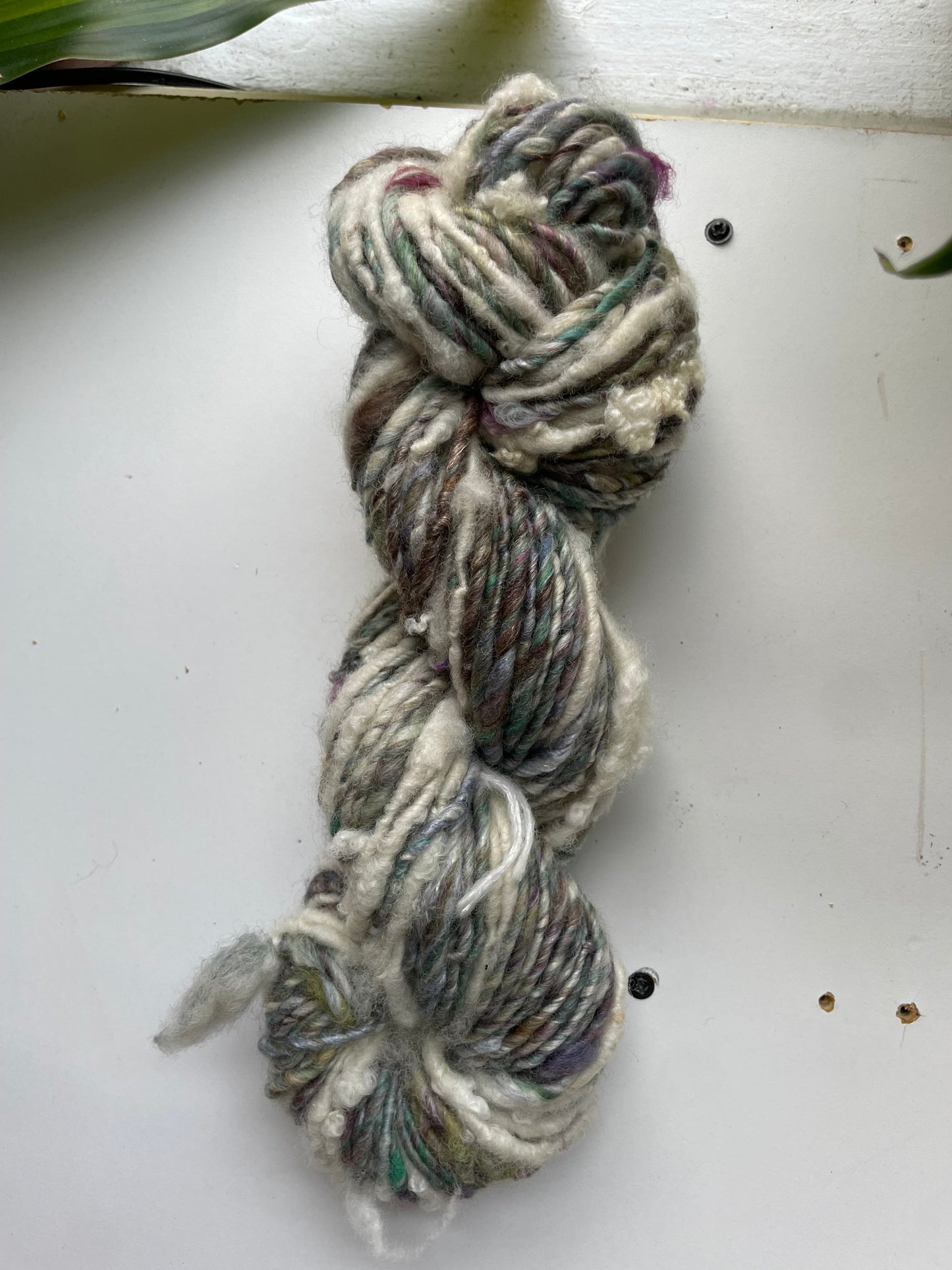 Braided yarn skein on a white surface
