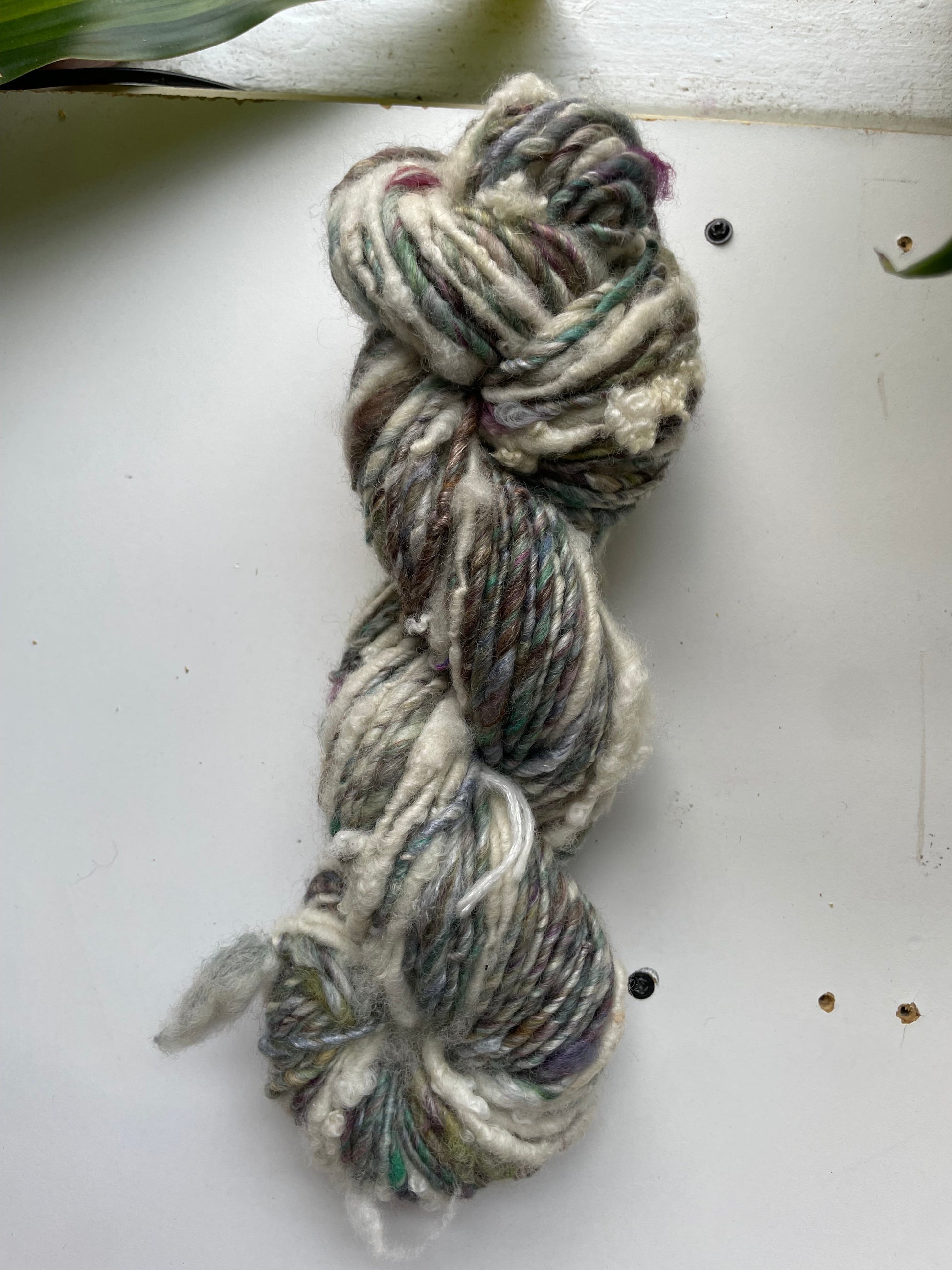 Braided yarn skein on a white surface