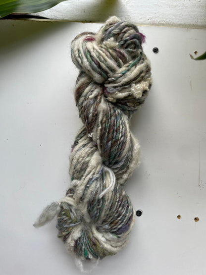 Braided yarn skein on a white surface