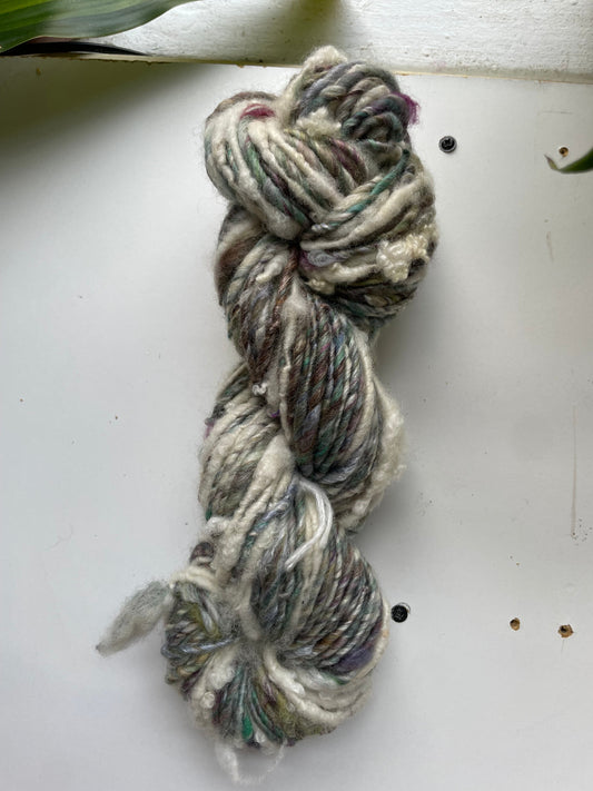 Braided yarn skein on a white surface